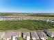 Scenic aerial view of a residential community showcasing the neighborhood's layout and surrounding landscape at 10741 Charlotte Dr, Parrish, FL 34219