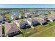 Picturesque aerial view of a community with homes surrounding a lake, perfect for a relaxing lakeside living at 10741 Charlotte Dr, Parrish, FL 34219