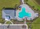 An overhead shot displays the unique pool design and clubhouse within a well-maintained community with parking and landscaping at 10741 Charlotte Dr, Parrish, FL 34219