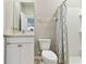 Clean bathroom featuring a vanity with modern fixtures, standard toilet, and shower with patterned curtain at 10741 Charlotte Dr, Parrish, FL 34219