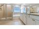 Bright bathroom featuring a glass shower, soaking tub, and double sink vanity at 10741 Charlotte Dr, Parrish, FL 34219