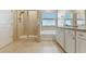 Bright bathroom featuring a glass shower, soaking tub, and double sink vanity at 10741 Charlotte Dr, Parrish, FL 34219