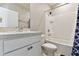 Bright bathroom with a shower-tub combo, white vanity, and framed mirror at 10741 Charlotte Dr, Parrish, FL 34219