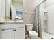Well-lit bathroom with a modern vanity, toilet, and a shower equipped with a stylish patterned curtain at 10741 Charlotte Dr, Parrish, FL 34219