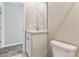 Bathroom featuring a white vanity, mirror, toilet, and tile flooring at 10741 Charlotte Dr, Parrish, FL 34219