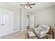 Bedroom with a ceiling fan, a comfy chair, and two closets at 10741 Charlotte Dr, Parrish, FL 34219