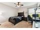 Comfortable bedroom features a ceiling fan, side table, and a dedicated computer area by the window at 10741 Charlotte Dr, Parrish, FL 34219