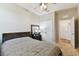Comfortable bedroom features a large bed with padded headboard, ceiling fan, dresser and warm natural lighting at 10741 Charlotte Dr, Parrish, FL 34219