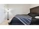Cozy bedroom showcasing a dark wood bed frame, side table, and carpet flooring at 10741 Charlotte Dr, Parrish, FL 34219