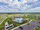 Aerial view of a large community pool, amenity center, with ample parking and playground at 10741 Charlotte Dr, Parrish, FL 34219