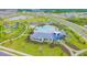 Aerial view of community amenities featuring a pool, playground, and surrounding green spaces at 10741 Charlotte Dr, Parrish, FL 34219