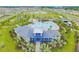 Aerial view of the neighborhood clubhouse with a large pool, playground, and ample green space at 10741 Charlotte Dr, Parrish, FL 34219