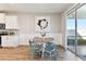 Bright dining area features wood floors, shiplap accent wall, and sliding glass doors to the outdoor patio at 10741 Charlotte Dr, Parrish, FL 34219