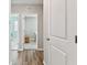 Hallway with wood floors leading to a laundry room and another room at 10741 Charlotte Dr, Parrish, FL 34219