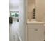 Hallway with views into the half-bath and living room featuring modern flooring and finishes at 10741 Charlotte Dr, Parrish, FL 34219