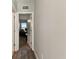 Hallway leading to a carpeted office space, offering privacy and functionality at 10741 Charlotte Dr, Parrish, FL 34219