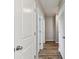 Hallway with wood floors, white doors and neutral colored walls at 10741 Charlotte Dr, Parrish, FL 34219