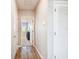 Hallway with wood floors, white doors and neutral colored walls leading to living room at 10741 Charlotte Dr, Parrish, FL 34219