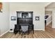 This home office features a black built-in desk with ample storage and stylish decor, set on wood-look flooring at 10741 Charlotte Dr, Parrish, FL 34219
