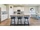 Bright, open kitchen featuring white cabinets, granite countertops, stainless steel appliances, and a large island with seating at 10741 Charlotte Dr, Parrish, FL 34219