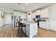 Spacious kitchen with white cabinets, granite countertops, stainless steel appliances and an island with barstool seating at 10741 Charlotte Dr, Parrish, FL 34219