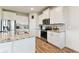 Well-appointed kitchen with white cabinets, granite countertops, stainless steel appliances, and wood-look flooring at 10741 Charlotte Dr, Parrish, FL 34219
