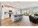 Bright, open kitchen featuring white cabinets, granite countertops, stainless steel appliances, and a large island with seating at 10741 Charlotte Dr, Parrish, FL 34219