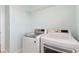 Bright laundry room features laundry machines, tile flooring and blue walls at 10741 Charlotte Dr, Parrish, FL 34219