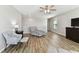Comfortable living room boasts wood floors, a ceiling fan, and ample natural light at 10741 Charlotte Dr, Parrish, FL 34219