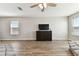 Spacious living room with wood floors, natural light, and a stylish console for entertainment at 10741 Charlotte Dr, Parrish, FL 34219