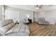 Bright living room with wood flooring and comfortable grey furniture, perfect for relaxation at 10741 Charlotte Dr, Parrish, FL 34219