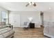 Cozy living room featuring wood floors, ceiling fan, and comfortable grey furniture sets at 10741 Charlotte Dr, Parrish, FL 34219
