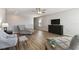Open living room showcases wood floors, neutral decor, and comfortable seating arrangements at 10741 Charlotte Dr, Parrish, FL 34219