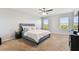 Spacious main bedroom with a ceiling fan, carpet flooring and large windows at 10741 Charlotte Dr, Parrish, FL 34219