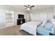 Spacious main bedroom with a ceiling fan, carpet flooring, tv and large windows at 10741 Charlotte Dr, Parrish, FL 34219