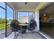 Screened-in patio featuring comfortable seating, a ceiling fan, and views of the backyard and neighboring homes at 10741 Charlotte Dr, Parrish, FL 34219