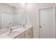 Bathroom featuring double sinks, modern faucets, and quartz counters at 12160 Cattleside Dr, Riverview, FL 33579