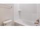 Bright bathroom featuring a tub with stylish textured tile surround and gold hardware at 12160 Cattleside Dr, Riverview, FL 33579