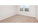 Cozy empty bedroom with neutral carpet, base molding, and natural light from windows at 12160 Cattleside Dr, Riverview, FL 33579