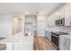 Bright kitchen features white cabinets, stainless steel appliances, and a large island with a sink at 12160 Cattleside Dr, Riverview, FL 33579