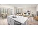 Bright, open-concept living room and dining area with modern furnishings and plenty of natural light at 12160 Cattleside Dr, Riverview, FL 33579