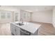 Bright, open-concept living room and dining area with island and plenty of natural light at 12160 Cattleside Dr, Riverview, FL 33579
