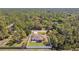 Lovely aerial view of a single Gathering home showcasing a screened in patio and a well-maintained lawn with white fence at 1221 Dustin Rd, North Port, FL 34288