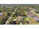 Expansive aerial view of a home with tile roof and a white fenced in yard surrounded by lush greenery and trees at 1221 Dustin Rd, North Port, FL 34288