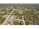 Wide aerial view of a peaceful residential neighborhood, showcasing the tranquility of single Gathering homes surrounded by green scenery at 1221 Dustin Rd, North Port, FL 34288