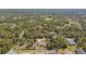 Stunning aerial view of a fenced single Gathering home nestled among the lush trees, providing peace and privacy at 1221 Dustin Rd, North Port, FL 34288