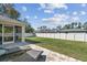 Spacious backyard with lush lawn, privacy fence, and an inviting patio area at 1221 Dustin Rd, North Port, FL 34288