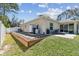 Spacious backyard featuring a patio, retaining wall with rock bed, and lush green lawn at 1221 Dustin Rd, North Port, FL 34288