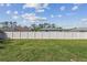 Fenced backyard with well-maintained grass and a view of neighboring houses under a bright sky at 1221 Dustin Rd, North Port, FL 34288