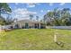 Large backyard with manicured lawn, patio area, and screened-in porch, perfect for outdoor living at 1221 Dustin Rd, North Port, FL 34288